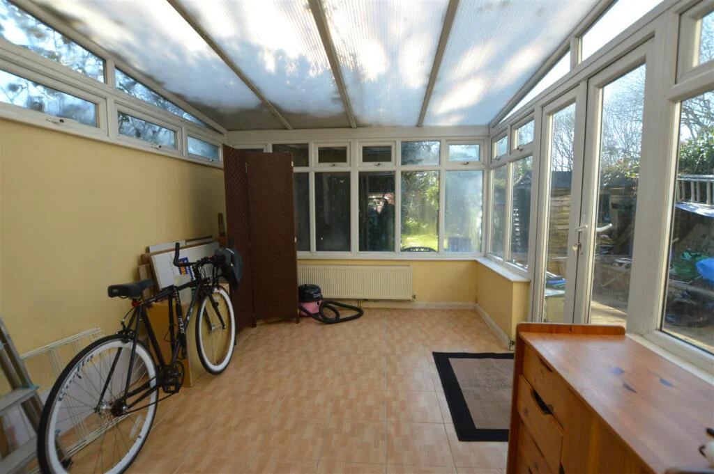 Bright conservatory opening onto the garden