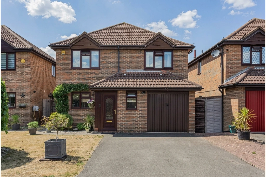 A detached brick property with a landscaped garden